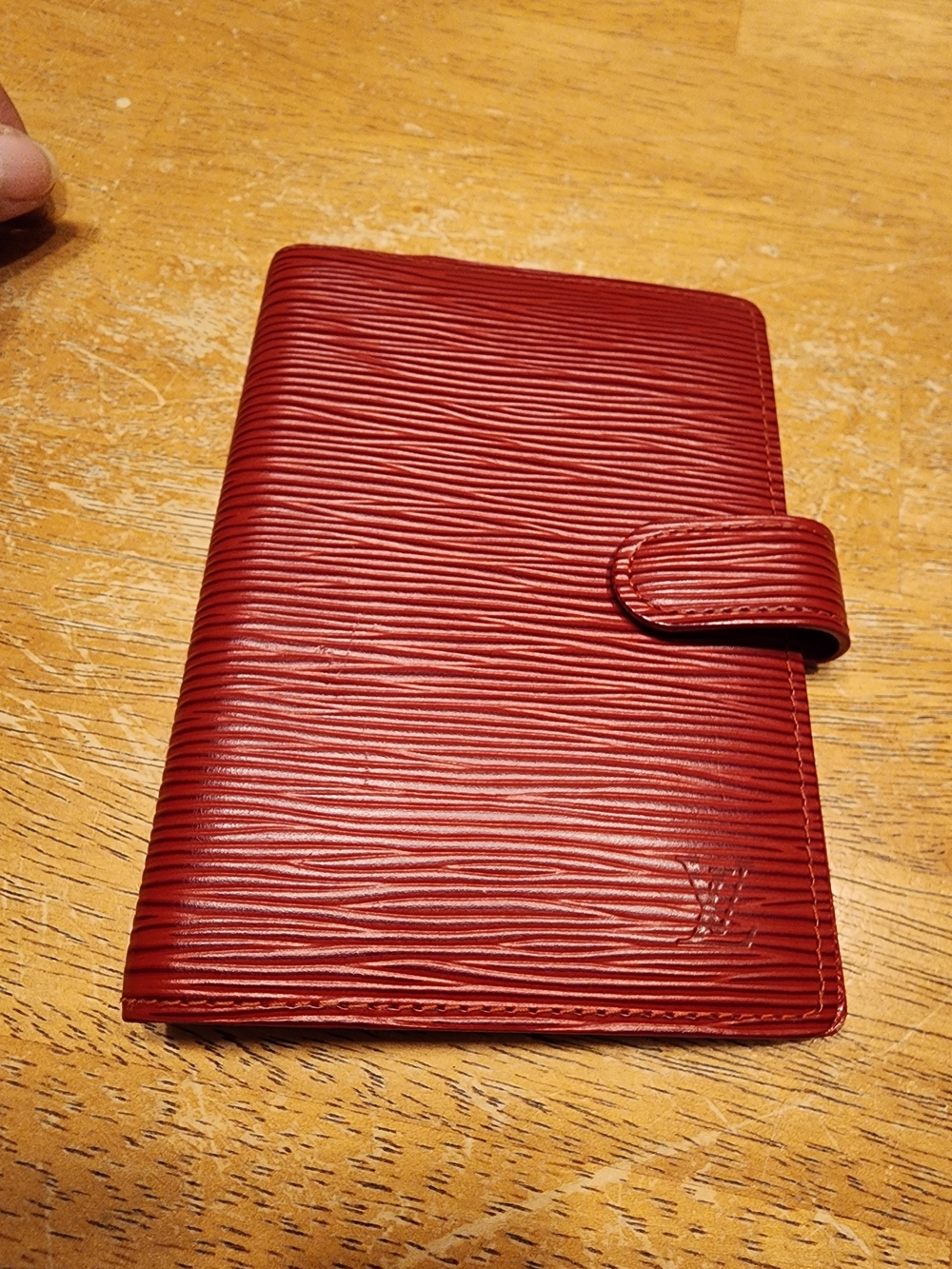 Louis Vuitton Agenda PM notebook cover in red Epi leather.